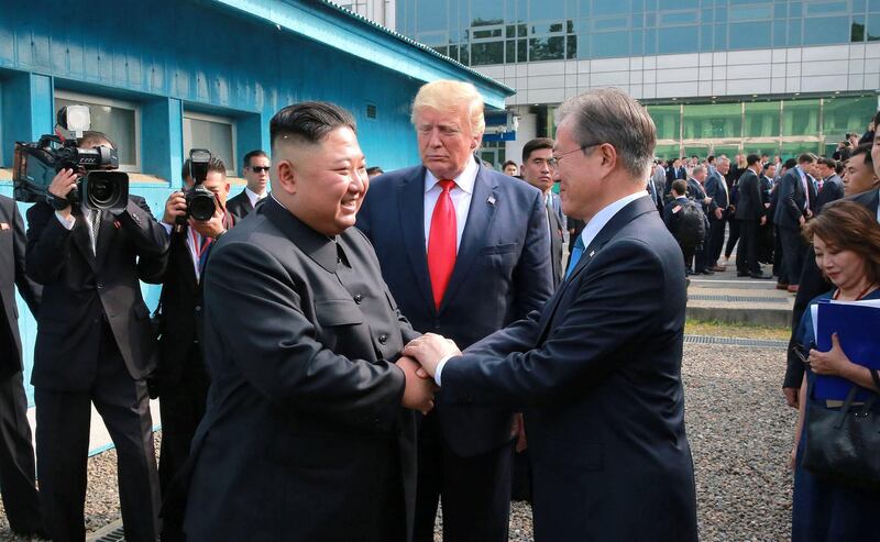 This picture taken on June 30, 2019 and released by North Korea's official Korean Central News Agency (KCNA) on July 1, 2019 shows North Korea's leader Kim Jong Un (L) meeting South Korea's President Moon Jae-in (R) and US President Donald Trump (C) on the south side of the Military Demarcation Line that divides North and South Korea, in the Joint Security Area (JSA) of Panmunjom in the Demilitarized zone (DMZ). (Photo by KCNA VIA KNS / KCNA VIA KNS / AFP) / South Korea OUT / REPUBLIC OF KOREA OUT   ---EDITORS NOTE--- RESTRICTED TO EDITORIAL USE - MANDATORY CREDIT "AFP PHOTO/KCNA VIA KNS" - NO MARKETING NO ADVERTISING CAMPAIGNS - DISTRIBUTED AS A SERVICE TO CLIENTS / THIS PICTURE WAS MADE AVAILABLE BY A THIRD PARTY. AFP CAN NOT INDEPENDENTLY VERIFY THE AUTHENTICITY, LOCATION, DATE AND CONTENT OF THIS IMAGE --- / 
