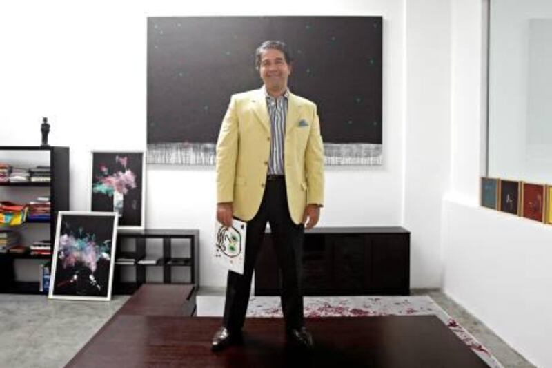 Al Quoz - November 10, 2011- Ramin Salsali, founder of the SPM Private Museum, holding a painting by his ten-year-old son Douglas titled "Papi" in his office at the museum in Al Quoz 1, Dubai, November 10, 2011. (Photo by Jeff Topping/The National) 

 