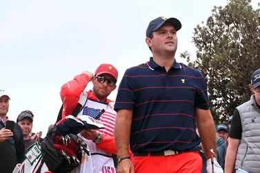 Caddie Kessler Karain (L) follows his player Patrick Reed during the third day of the Presidents Cup in Melbourne. AFP