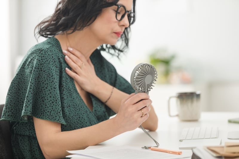 Hot flushes can be debilitating for some women, which has increasingly led to conversations around menopause support at the workplace. Getty Images