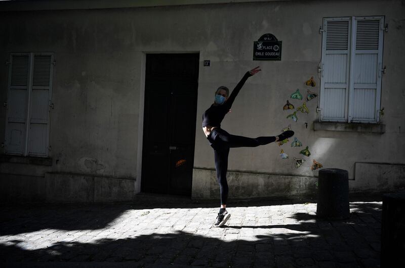 Irish dancer from the Moulin Rouge, Isabelle, practices in the street next to her home in Paris on April 14, 2020, on the 29th day of a strict lockdown aimed at curbing the spread of the COVID-19 pandemic, caused by the novel coronavirus. / AFP / FRANCK FIFE
