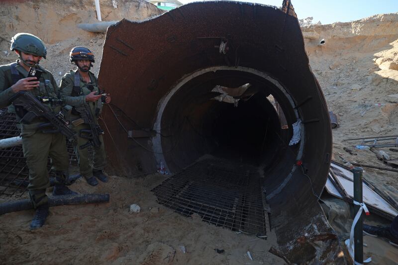 Israeli soldiers at an entrance to the tunnel in northern Gaza. EPA