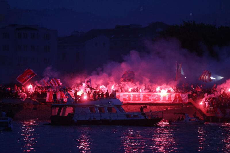 Supporters light flares on the bank of the Sava river after Red Star Belgrade won the Serbian SuperLiga. AFP