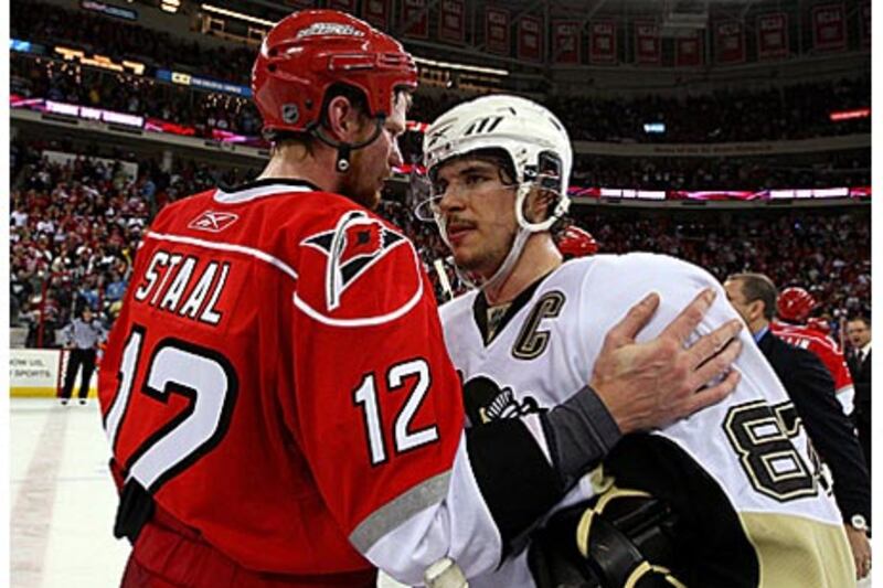 Sidney Crosby, right, captain of the Pittsburgh Penguins is congratulated by Carolina's Eric Staal after their 4-1 win in Game Four.