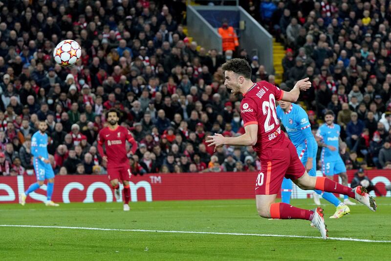 Liverpool's Diogo Jota heads home to open the scoring. AP