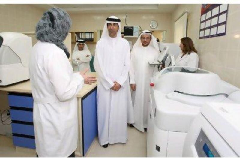 Dr Hanif Hassan Ali, centre, the Minister of Health, attends the opening of the Al Qarain Health Care Centre in Sharjah with Dr Mahmoud Fikri, second from right, the chief executive for health policies affairs, Ministry of Health.