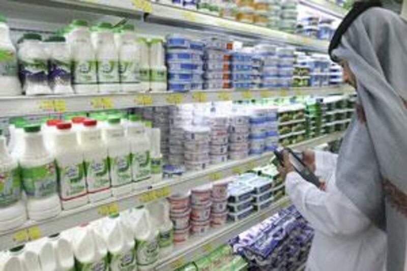 A food inspector examines dairy produce in a supermarket in Abu Dhabi.