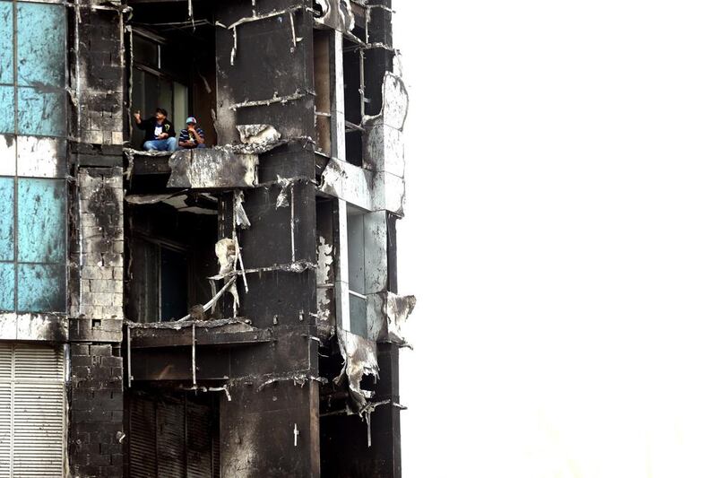  Fire department officials inspect damage to the Torch tower. Getty Images  