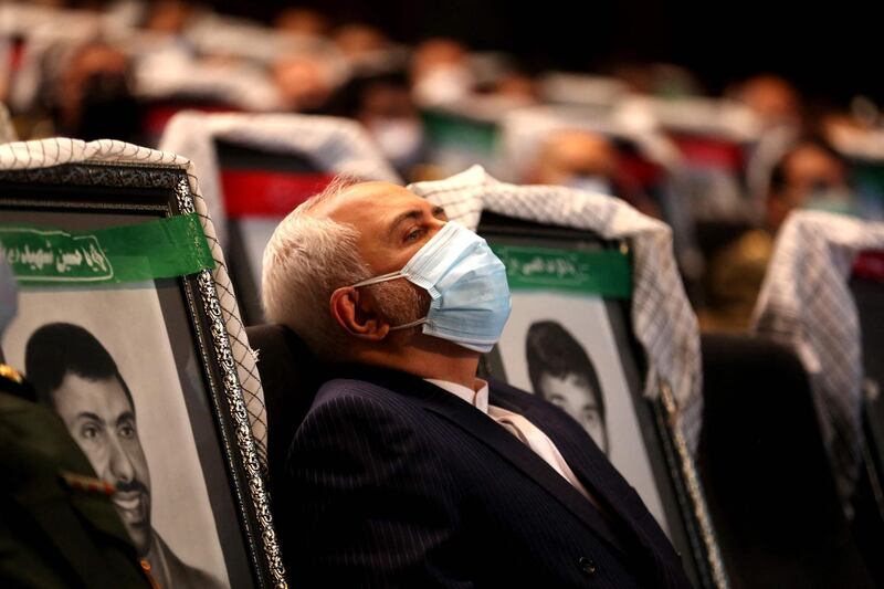Iranian Foreign Minister Mohammad Javad Zarif listens to a speach during the the International Conference on the Legal-International Claims of the Holy Defense in the capital Tehran on February 23, 2021.  / AFP / ATTA KENARE
