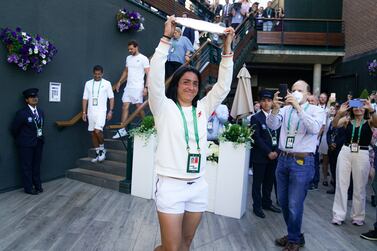 Ons Jabeur greets her supporters with the runners up trophy following defeat to Elena Rybakina in The Final of the Ladies' Singles on day thirteen of the 2022 Wimbledon Championships at the All England Lawn Tennis and Croquet Club, Wimbledon. Picture date: Saturday July 9, 2022.