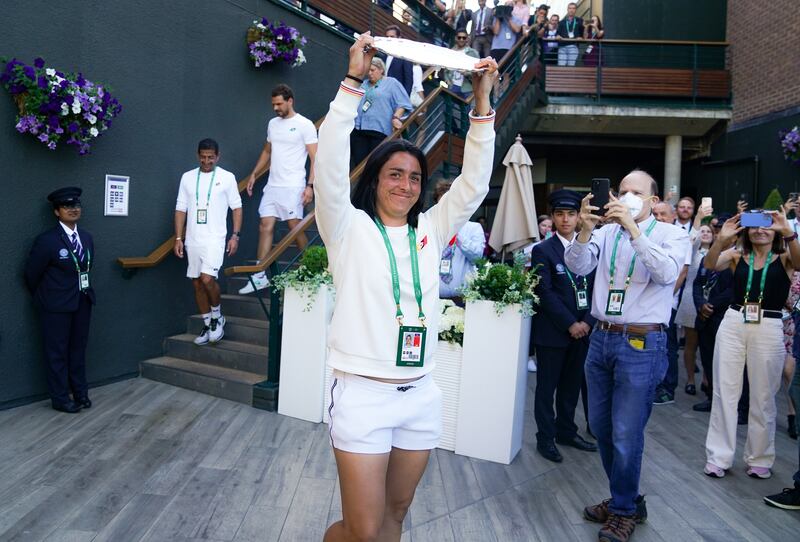 Ons Jabeur greets her supporters with the runners-up Wimbledon trophy. PA