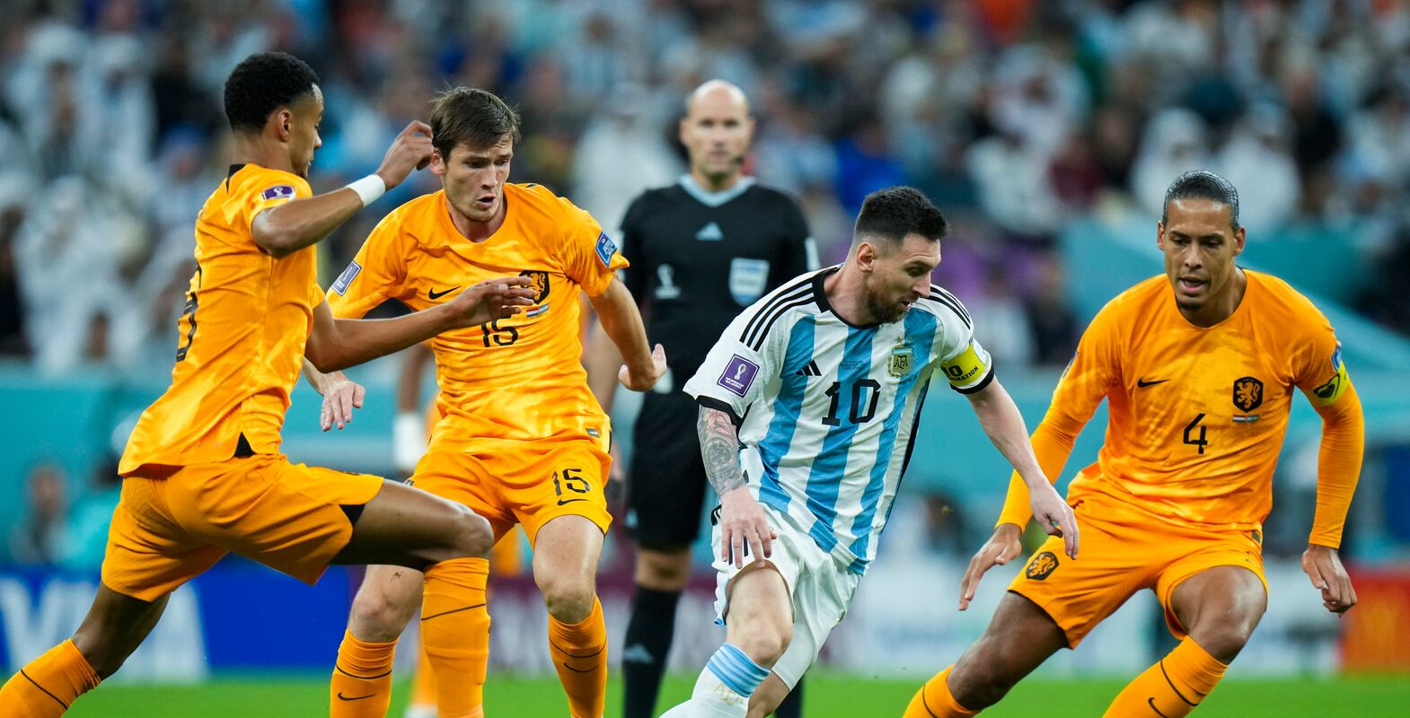 Argentina's Lionel Messi, second right, vies for the ball with Netherlands' defenders during the World Cup quarterfinal soccer match between the Netherlands and Argentina, at the Lusail Stadium in Lusail, Qatar, Friday, Dec.  9, 2022.  (AP Photo / Francisco Seco)