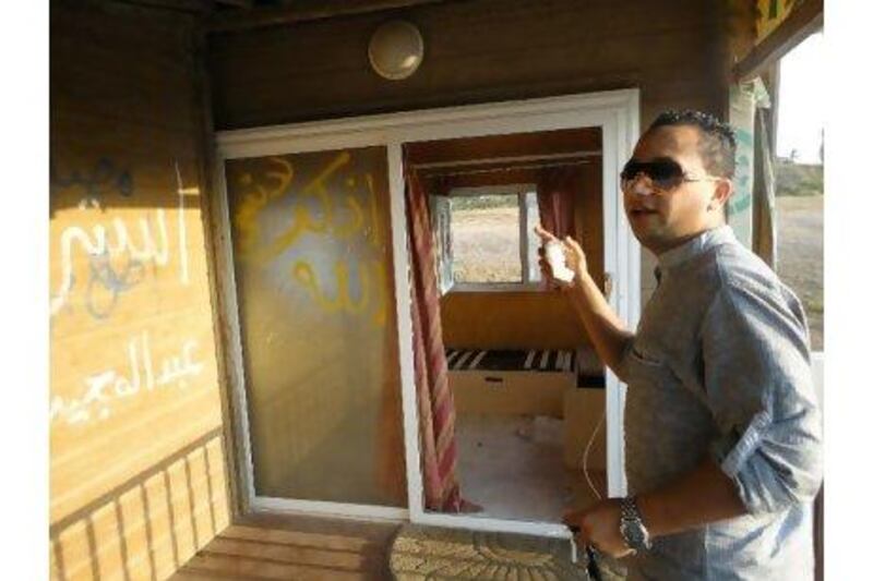 Alaa Murad, 24, tours a bungalow in the Tripoli beachfront getaway of Safia Qaddafi, Colonel Qaddafi's wife. The land belonged to Mr Murad's great-grandfather and he is hoping to get the deed back so that his family can build a new hotel and take advantage of a newly liberalised economy. Bradley Hope / The National