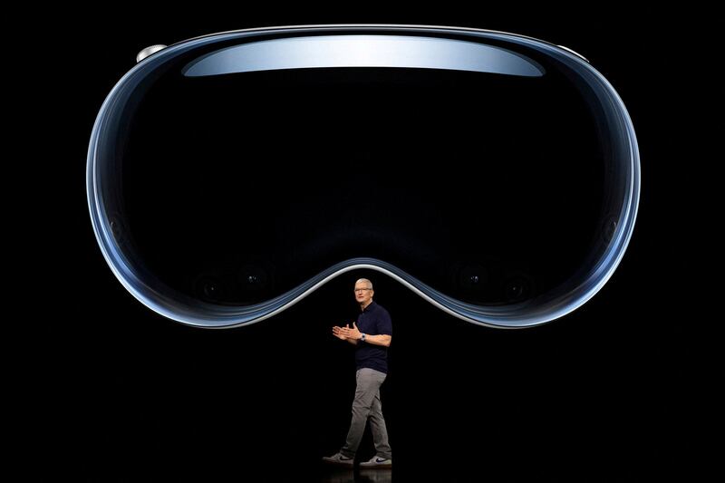 Apple CEO Tim Cook speaks under an image of Apple Vision Pro at Apple Park in Cupertino, California, on June 5. Reuters
