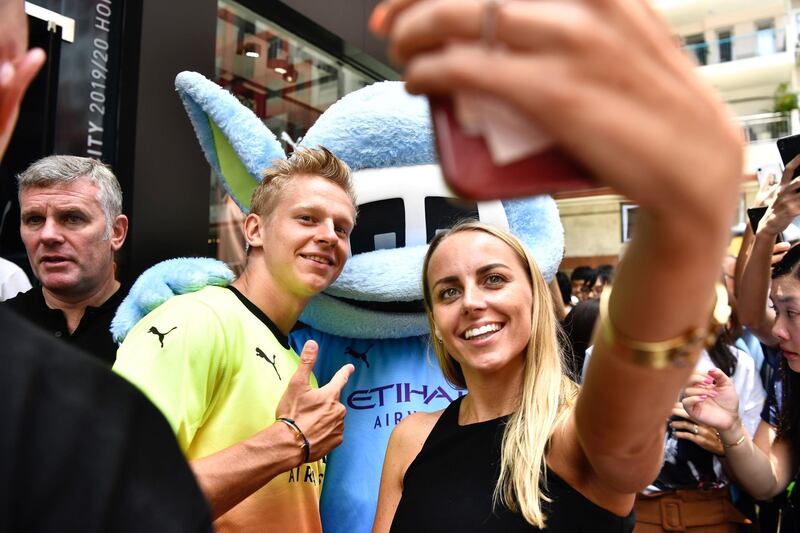 Oleksandr Zinchenko takes a selfie with a fan during a promotional event in Hong Kong. AFP