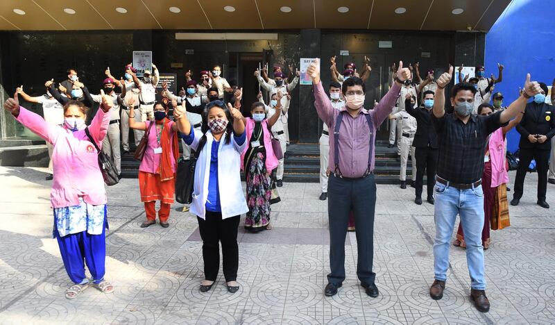 'Covid Warriors', including doctors, civil defence and other officials, pose for photographs before attending a special movie screening at a PVR Cineplex cinema hall in New Delhi, India. EPA