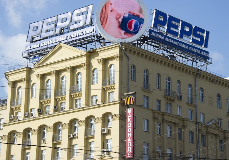 An advert for US soft drink giant Pepsi sits above a sign for a McDonald's restaurant in Moscow. AFP