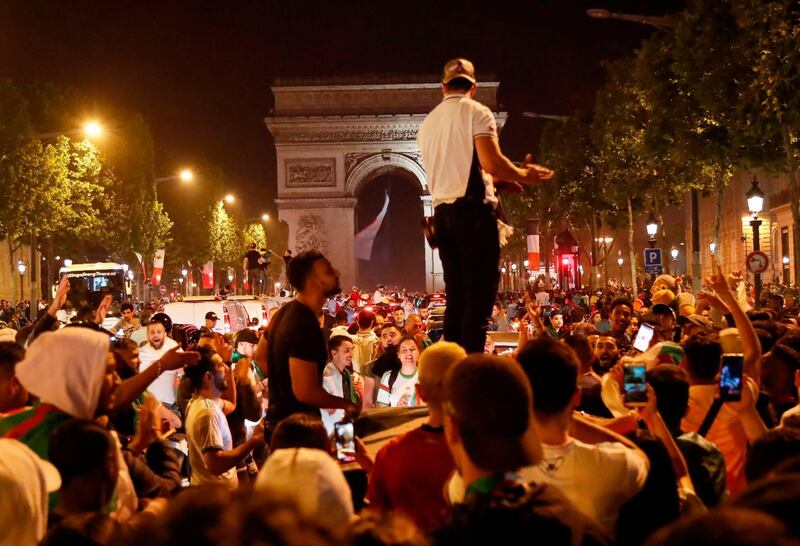 Algeria supporters celebrate on the Champs-Elysee avenue in Paris, France. AFP