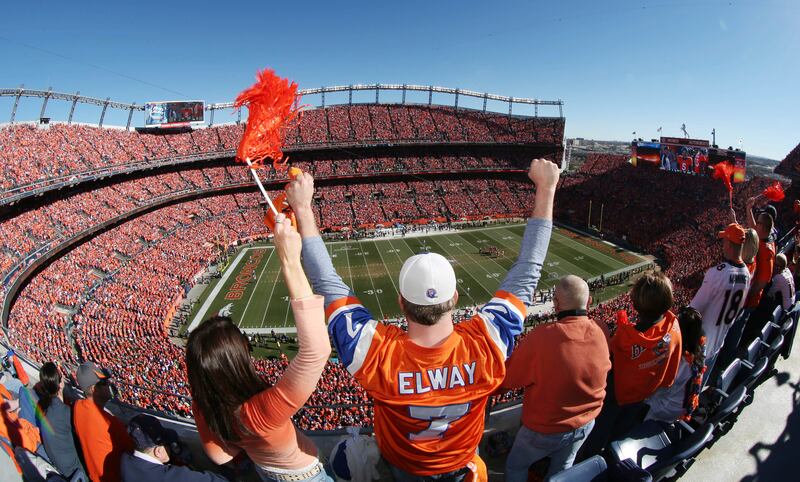 Denver Broncos fans cheer during a playoff game between the Broncos and the New England Patriots. The reported price tag for the Broncos would be the largest for a US sports franchise. Photo: AP