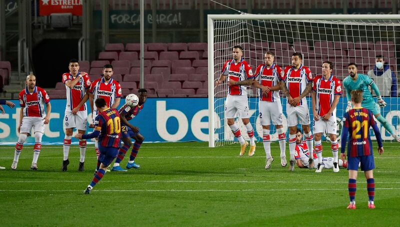 Barcelona's Lionel Messi shoots at goal from a free-kick on the edge of the penalty area. Reuters