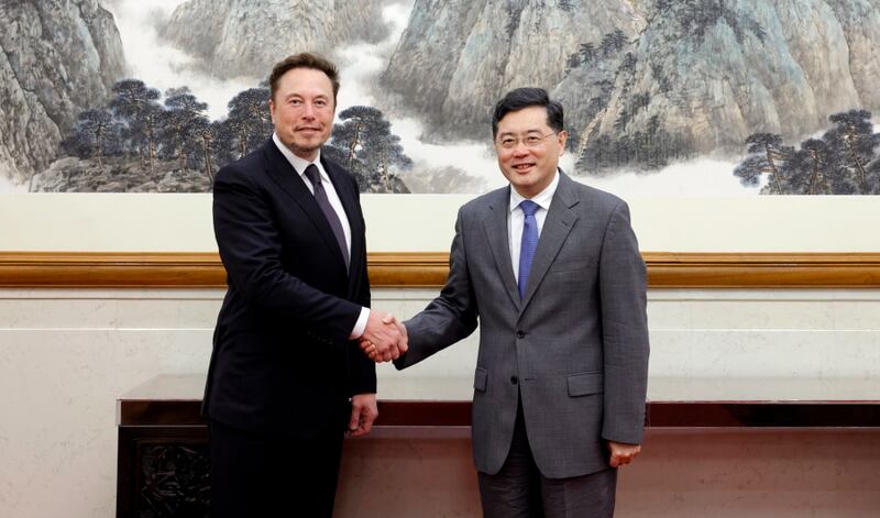 A handout photo released by the Ministry of Foreign Affairs of the People's Republic of China shows Tesla CEO Elon Musk (L) shaking hands with China's Foreign Minister Qin Gang during a meeting in Beijing, China. EPA / CHINA'S FOREIGN MINISTRY HANDOUT  HANDOUT