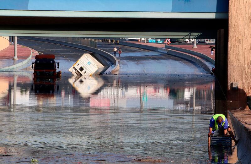 Municipality workers try to drain a flooded underpass in Kuwait City. AFP