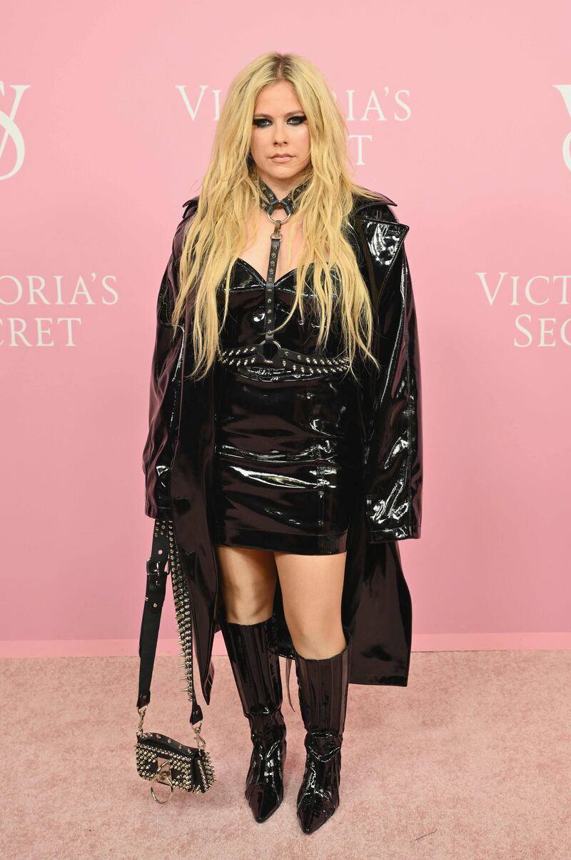 Avril Lavigne seems to have missed the mark, arriving in glossy faux-bondage garb. AFP