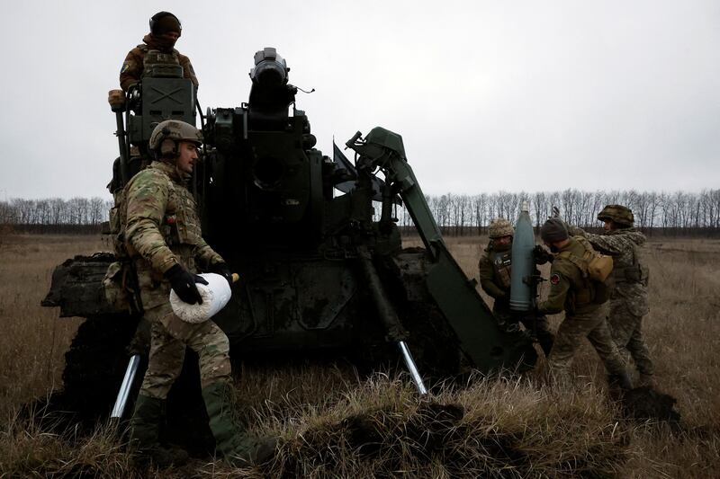 Ukrainian soldiers prepare to fire a cannon near the front line in Bakhmut. Reuters