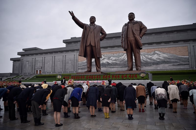 People bow at the statues of late North Korean leaders Kim Il-sung and Kim Jong-il on Mansu Hill, as part of celebrations to mark the 112th anniversary of the birth of Kim Il-sung, in Pyongyang. AFP