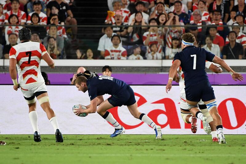 Scotland fly-half Finn Russell scores the first try of the game. AFP