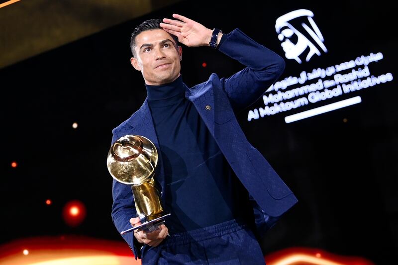Cristiano Ronaldo with one of the three trophies he won at the the 2023 Dubai Globe Soccer Awards. AP