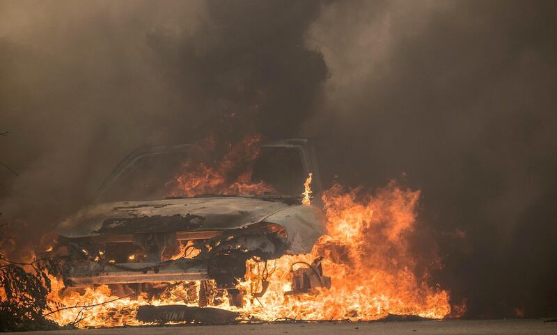 A vehicle burns during the 'Thomas Fire', which began overnight in Ventura, California. John Cetrino / EPA