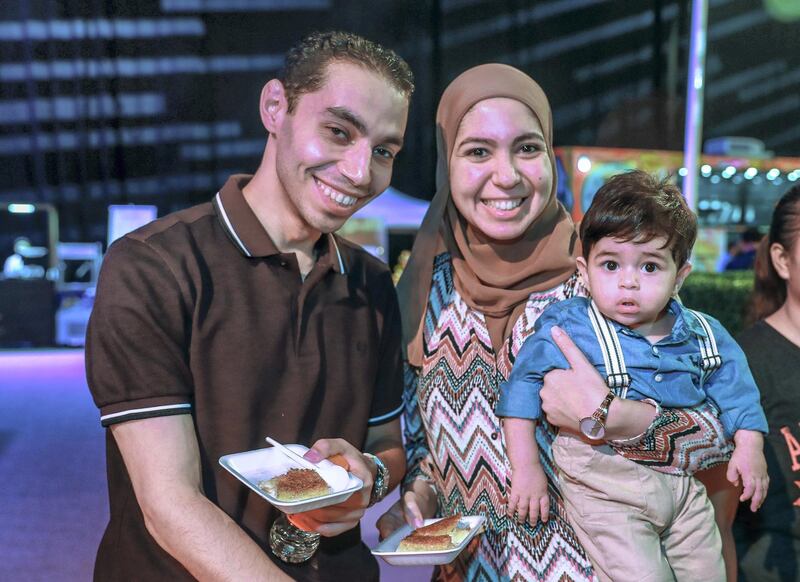 Abu Dhabi, U.A.E., May 30, 2018.  Ramadan Exhibition at ADNEC.   Nayera and Mohammad Ramadan with son Yahya enjoy the Ramadan exhibition.
Victor Besa / The National
Reporter:  Saeed Saeed
Section:  Arts & Culture