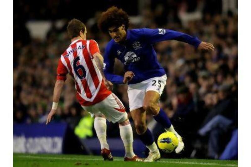 Everton's Marouane Fellaini, right, competes with Stoke's Glenn Whelan at Goodison Park. Alex Livesey / Getty Images