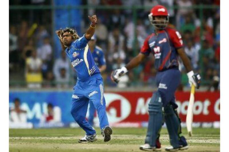 Mumbai Indians' Lasith Malinga, left, celebrates after claiming the wicket of Delhi Daredevils' Venugopal Rao.