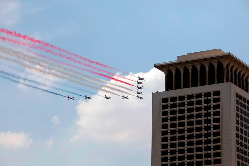 Egyptian jet fighters trail smoke as they fly over the capital Cairo on June 2, 2018, during the inauguration of the Egyptian President Abdel Fattah al-Sisi for a second four-year term in office during a special parliament session. Egyptian President Abdel Fattah al-Sisi was sworn in on Saturday for a second four-year term in office during a special parliament session broadcast live on state television. Sisi took the oath in a packed house and in front of members of his government, after winning 97 percent of valid votes in the March presidential election.
 / AFP / STR
