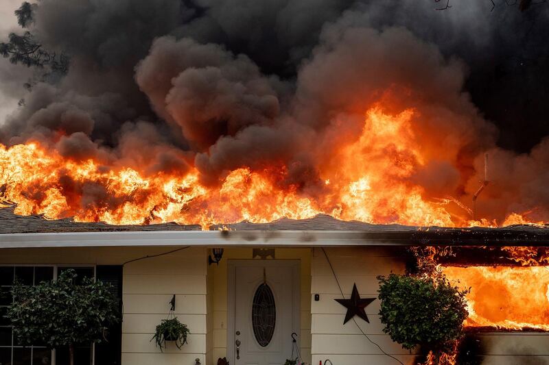 Flames consume a home as the Camp Fire tears through Paradise, California. AP Photo