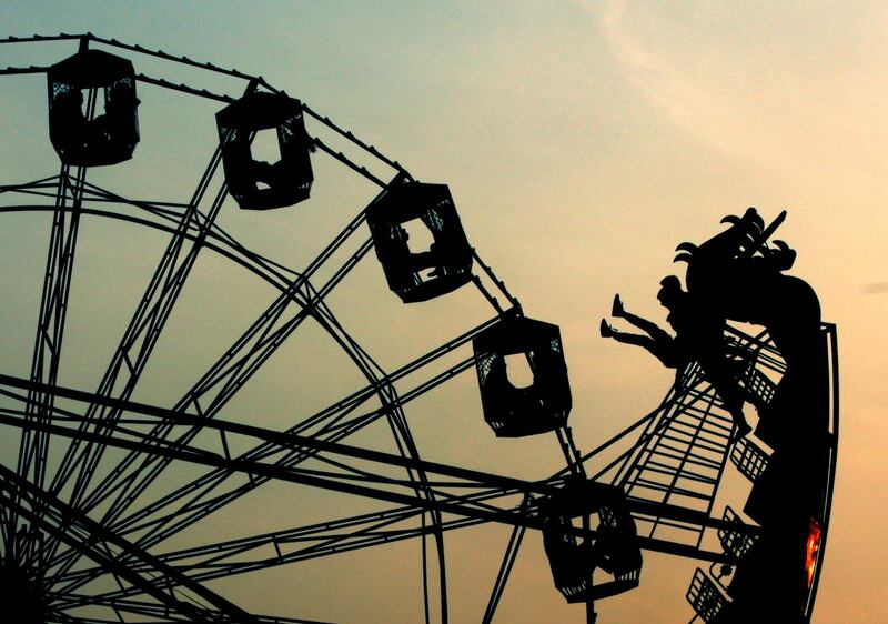 Indian people react on a ride during the annual farmer fair at Shama Chak Jhiri, about 22km from Jammu, the winter capital of Kashmir, India. EPA