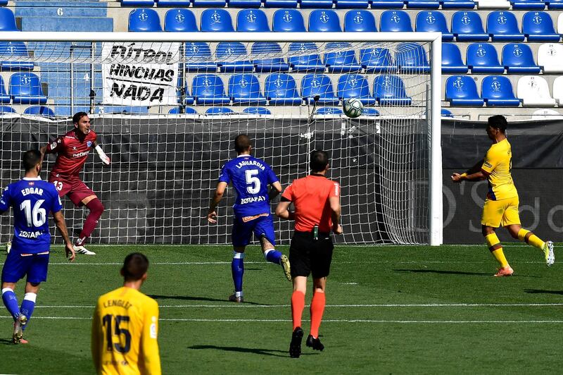 Barcelona's Luis Suarez, right, scores heads home his side's third goal. AP Photo