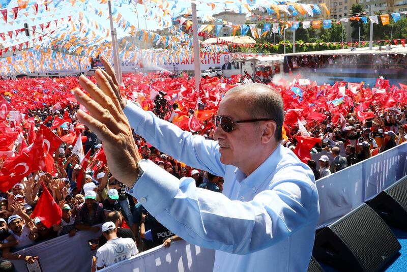 Turkey's President and ruling Justice and Development Party leader Recep Tayyip Erdogan waves as he addresses his supporters during an election rally in Sanliurfa, Turkey, Wednesday, June 20, 2018. 'Turkey holds parliamentary and presidential elections on June 24, 2018, deemed important as it will transform Turkey's governing system to an executive presidency.(Presidential Press Service via AP, Pool)