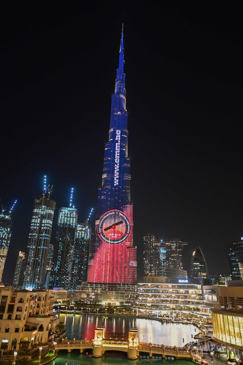 A picture taken on July 19, 2020 shows Dubai's Burj Khalifa lit up in support of the United Arab Emirates "Hope" Mars probe, ahead of it's expected launch from Japan. The probe is one of three racing to the Red Planet, with Chinese and US rockets also taking advantage of the Earth and Mars being unusually close: a mere hop of 55 million kilometres (34 million miles). "Hope" -- Al-Amal in Arabic -- is expected to start orbiting Mars by February 2021, marking the 50th anniversary of the unification of the UAE. / AFP / Giuseppe CACACE
