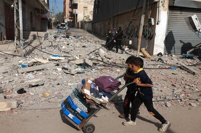 Young boys with a load of personal belongings in Rafah in the southern Gaza Strip. AFP