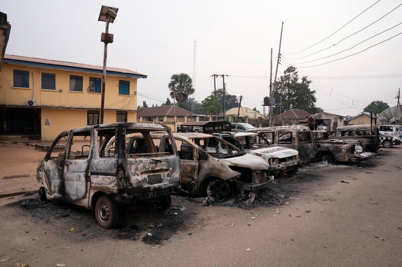 Burned vehicles are parked outside the police command headquarters in Owerri, Nigeria. Hundreds of inmates escaped from a prison in the southeastern Nigerian city after a series of coordinated attacks, according to government officials. AP Photo