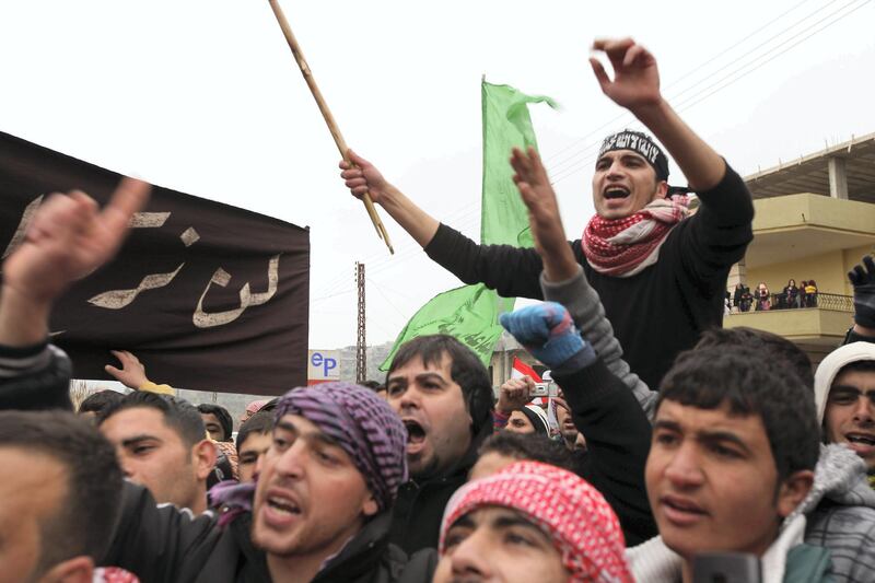 Demonstrators shout slogans against the Syrian regime during a protest following the Friday prayers in Wadi Khaled on the Lebanese-Syrian border on December 30, 2011. Monitors say more than 9,100 people have been killed in the Syrian unrest that started with peaceful protests in March 2011 before turning into an armed revolt, faced with a brutal crackdown which has cost dozens of lives each day. AFP PHOTO/SI MITCHELL (Photo by Si Mitchell / AFP)