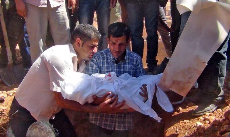 Abdullah Al Kurdi, father of the drowned three-year-old boy Aylan Kurdi, holds his son's body before burying him in Kobani, Syria, 04 September 2015. Dicle New Agency / EPA