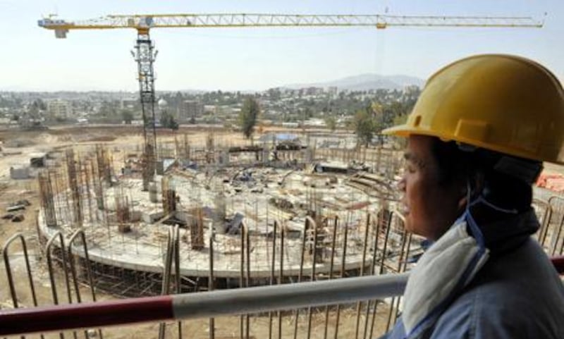 A Chinese worker looks out on the site of the new African Union conference centre in Addis Ababa, which is being built, free of charge, by the Chinese government.