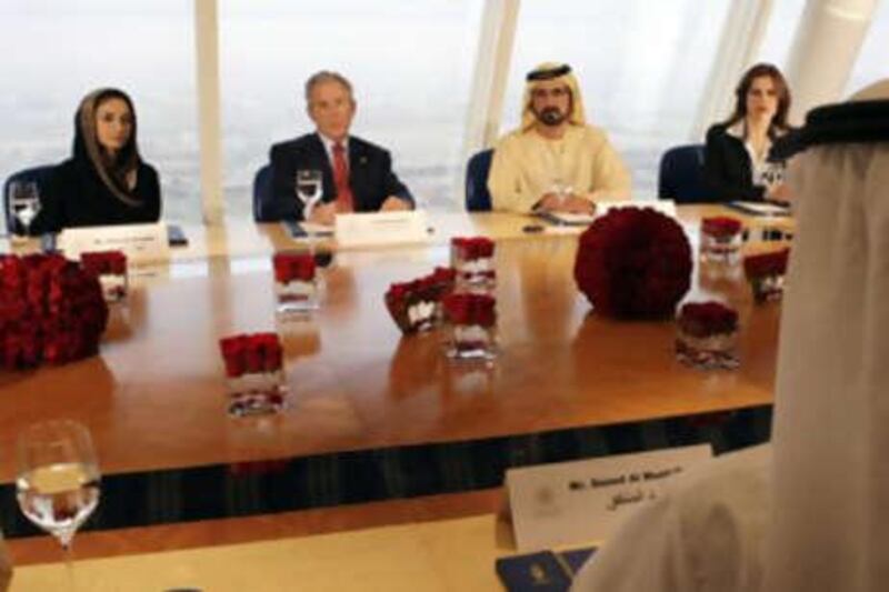 Sheikh Mohammed bin Rashid, Vice President of the UAE and Ruler of Dubai, President George W Bush, and Saeed al Muntafiq at a meeting earlier this year in Dubai with Najla al Awadhi, the deputy chief executive of Dubai Media Incorporated and a member of the Federal National Council (left) and Maha al Ghunaim, the founder and chairman of Kuwait's Global Investment House (right).
