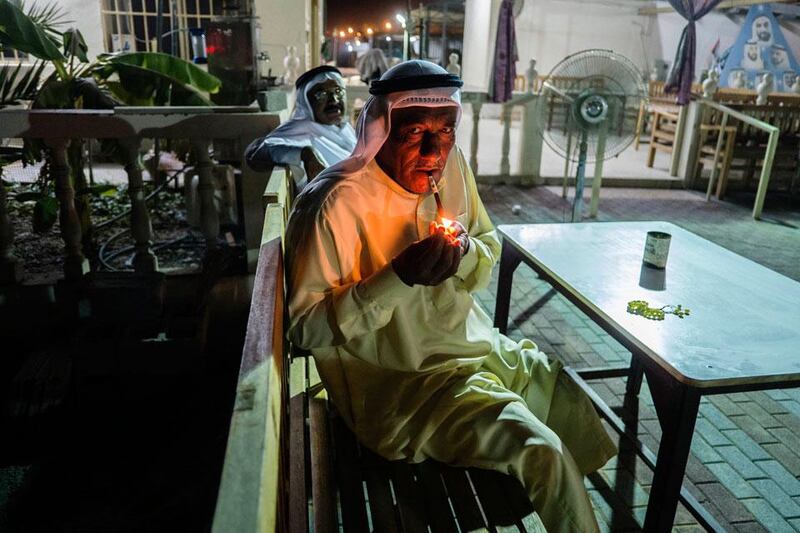Saeed relaxes outside in the cool evening with his midwakh, or Arabian  
pipe, in which he smokes dokha, a sifted tobacco product mixed with  
aromatic leaf and bark herbs.
