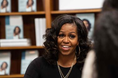 Former US First Lady Michelle Obama meets with fans during a book signing on the first anniversary of the launch of her memoir 'Becoming' at the Politics and Prose bookstore in Washington, DC, on November 18, 2019. AFP