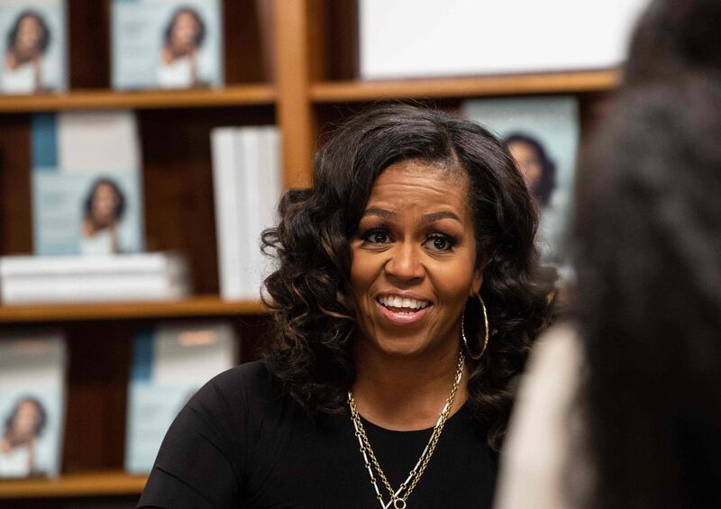 (FILES) In this file photo former US First Lady Michelle Obama meets with fans during a book signing on the first anniversary of the launch of her memoir "Becoming" at the Politics and Prose bookstore in Washington, DC, on November 18, 2019. Michelle Obama will star in a new documentary out next week which follows the former first lady's global book tour for her smash-hit memoir, Netflix said April 27, 2020. "Becoming," out May 6, is the Obamas' latest collaboration with the streaming giant after last year's "American Factory," which won the best documentary Oscar in February.
 / AFP / NICHOLAS KAMM
